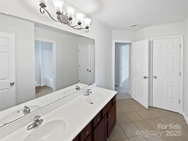 a spacious bathroom with a double vanity sink and a mirror