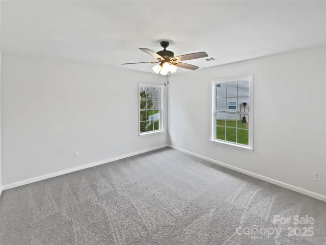 a view of a room with a ceiling fan and a window