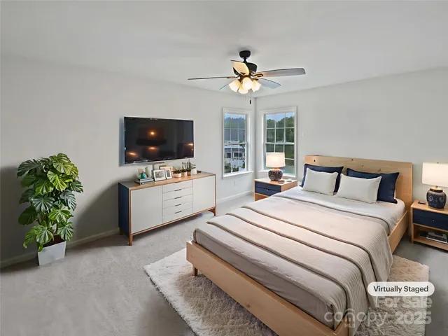 a bedroom with bed and a flat screen tv