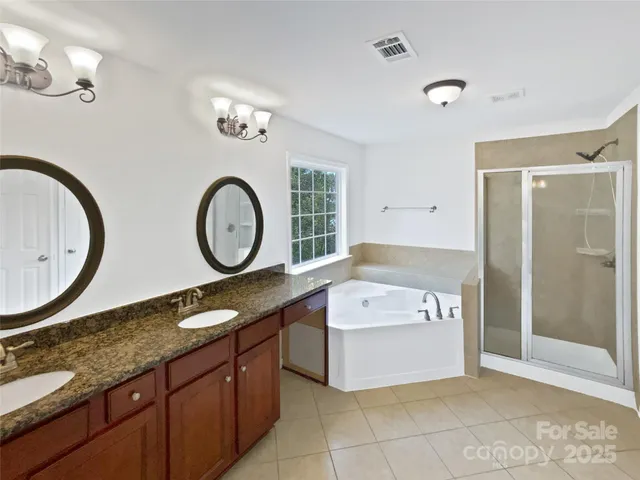 a bathroom with a tub sink and mirror