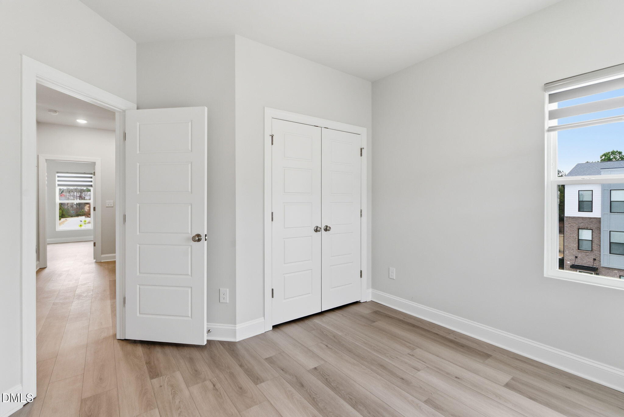 501 Hedrick Ridge Road Cary, NC 27519 - Photo 30 of 47 a view of an empty room and window with wooden floor