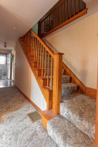 a bedroom with a bed chair and window