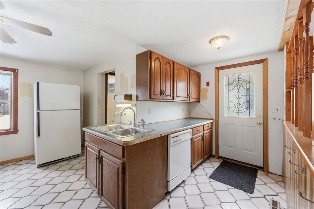 56 Percy Street Chicopee, MA 01020 - Photo 11 of 42 a kitchen with stainless steel appliances granite countertop a sink stove and refrigerator