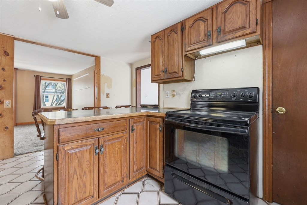 56 Percy Street Chicopee, MA 01020 - Photo 16 of 42 a kitchen with stainless steel appliances granite countertop a stove microwave and cabinets
