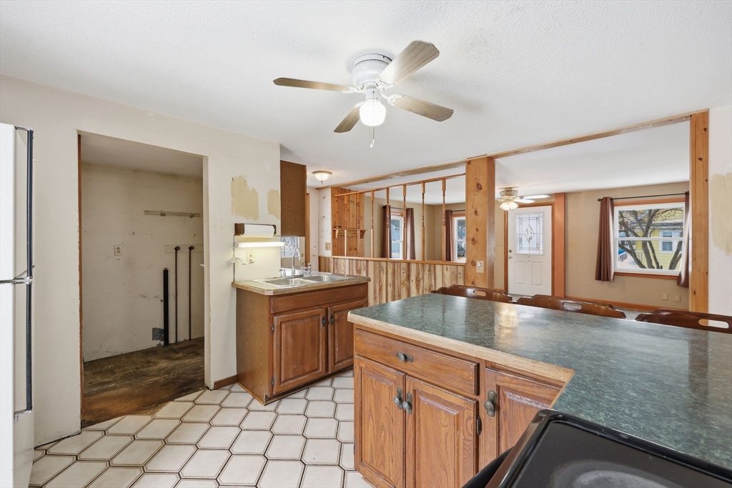 56 Percy Street Chicopee, MA 01020 - Photo 18 of 42 a large kitchen with kitchen island granite countertop a sink and a refrigerator