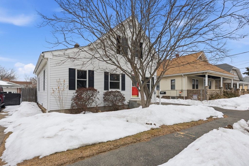 56 Percy Street Chicopee, MA 01020 - Photo 3 of 42 a front view of a house with a yard covered in snow