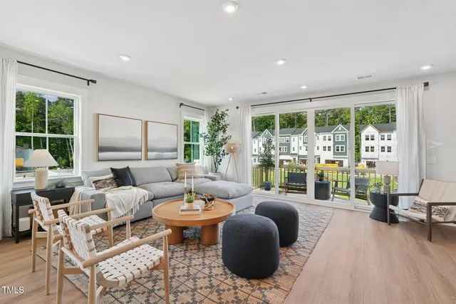 a living room with furniture a chandelier and a flat screen tv