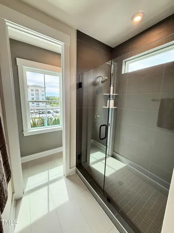 a bedroom with bed and a potted plant