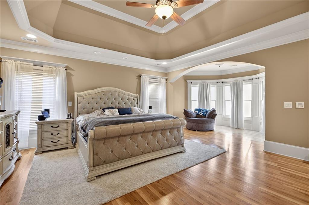 121 Carson Place Carrollton, GA 30117 - Photo 21 of 43 a bedroom with a large bed and a chandelier