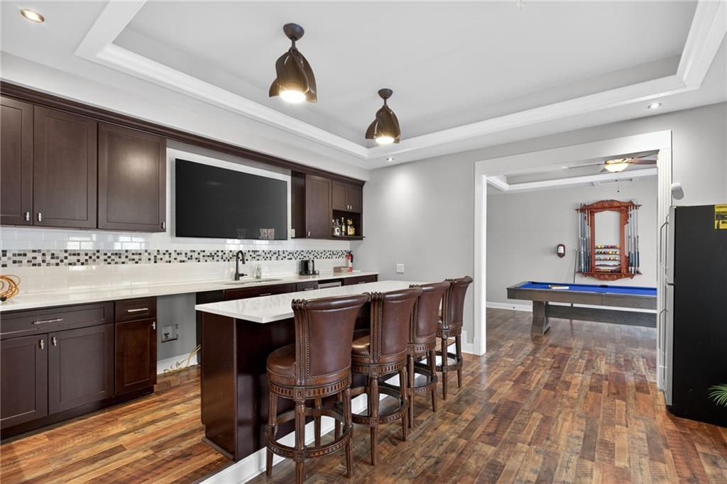 121 Carson Place Carrollton, GA 30117 - Photo 31 of 43 a kitchen with stainless steel appliances kitchen island granite countertop a table chairs sink and cabinets