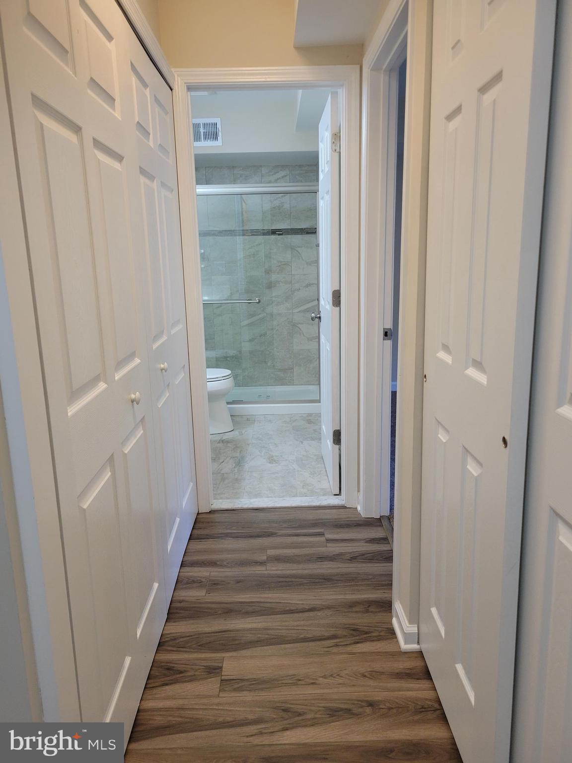 411 North Stiles Avenue, Unit E3 Maple Shade, NJ 08052 - Photo 13 of 14 a view of a hallway with wooden floor and staircase