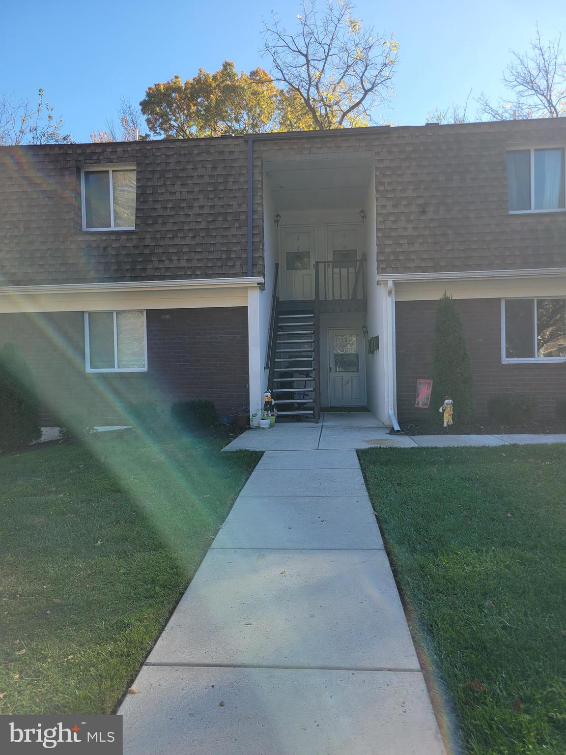 411 North Stiles Avenue, Unit E3 Maple Shade, NJ 08052 - Photo 2 of 14 front view of a house with a yard and a fire pit