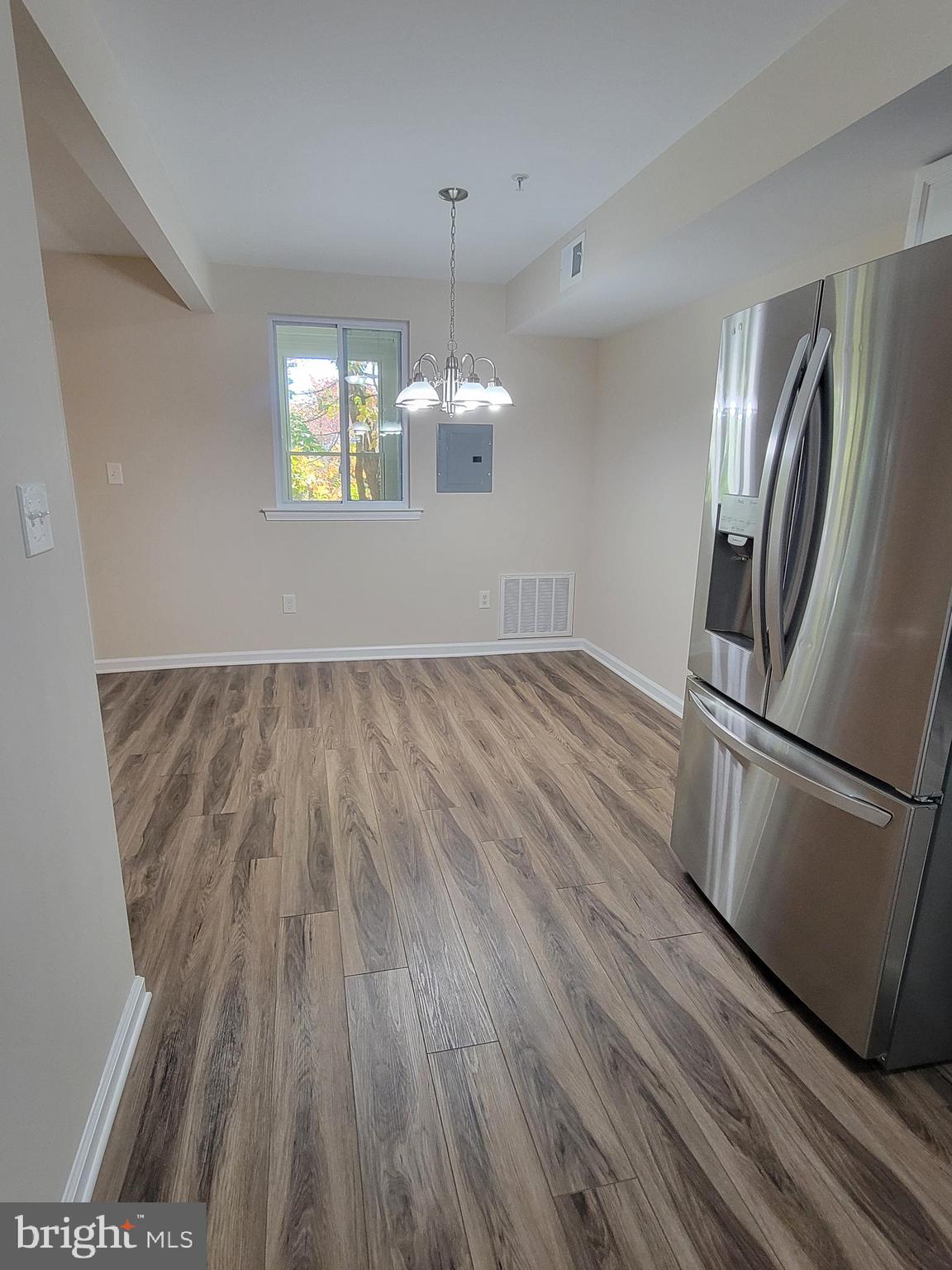411 North Stiles Avenue, Unit E3 Maple Shade, NJ 08052 - Photo 8 of 14 a view of a kitchen with a wooden floor and stainless steel appliances