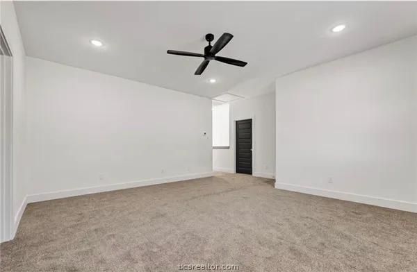 an empty room with closet and windows