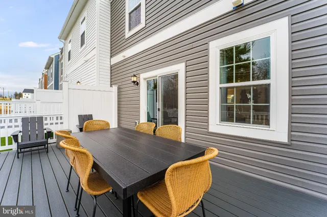 a view of deck with table and chairs and wooden floor