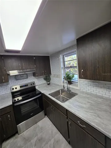 a kitchen that has a sink and a stove