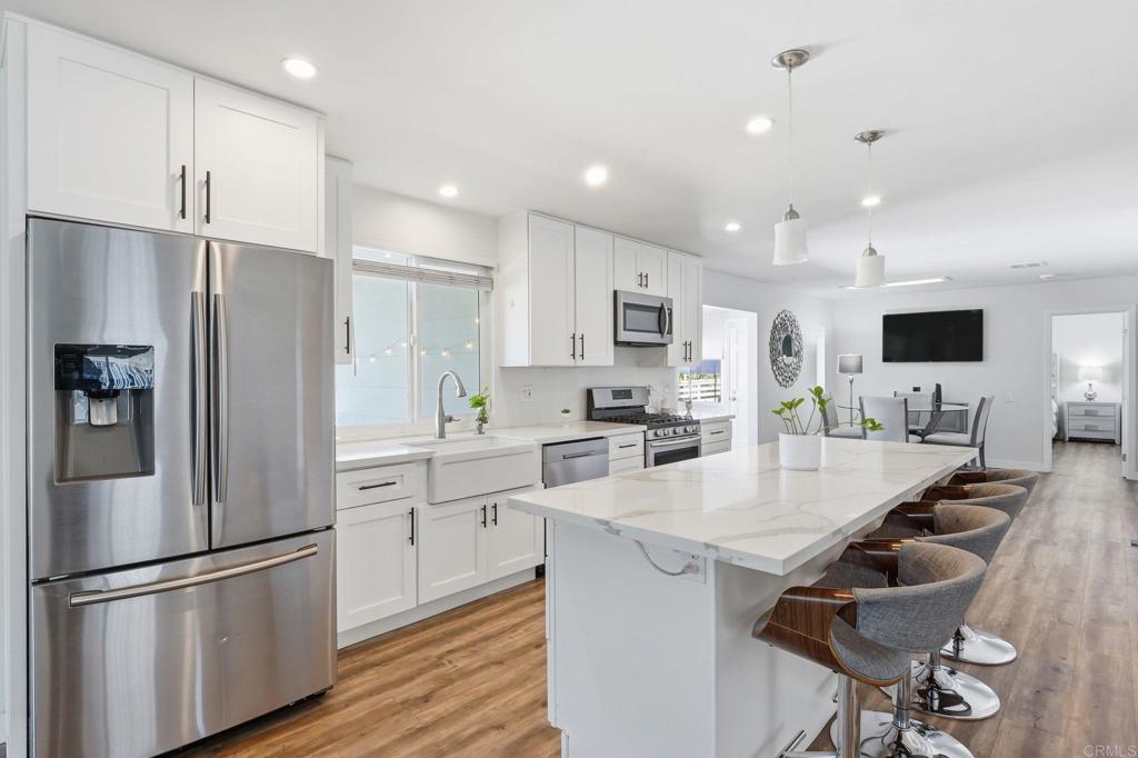 1195 La Moree Road, Unit 98 San Marcos, CA 92078 - Photo 17 of 28 a kitchen with kitchen island white cabinets and stainless steel appliances