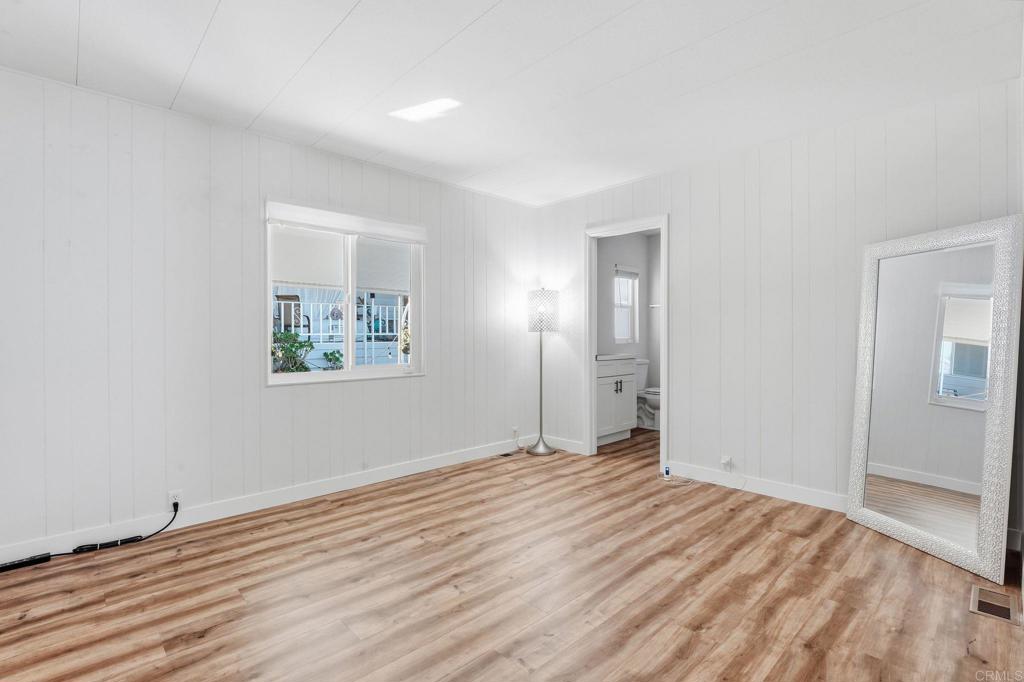 1195 La Moree Road, Unit 98 San Marcos, CA 92078 - Photo 21 of 28 an empty room with wooden floor and window