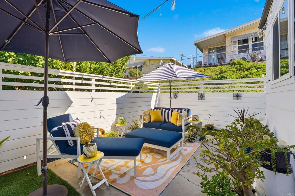 1195 La Moree Road, Unit 98 San Marcos, CA 92078 - Photo 24 of 28 a patio with tables and chairs under an umbrella