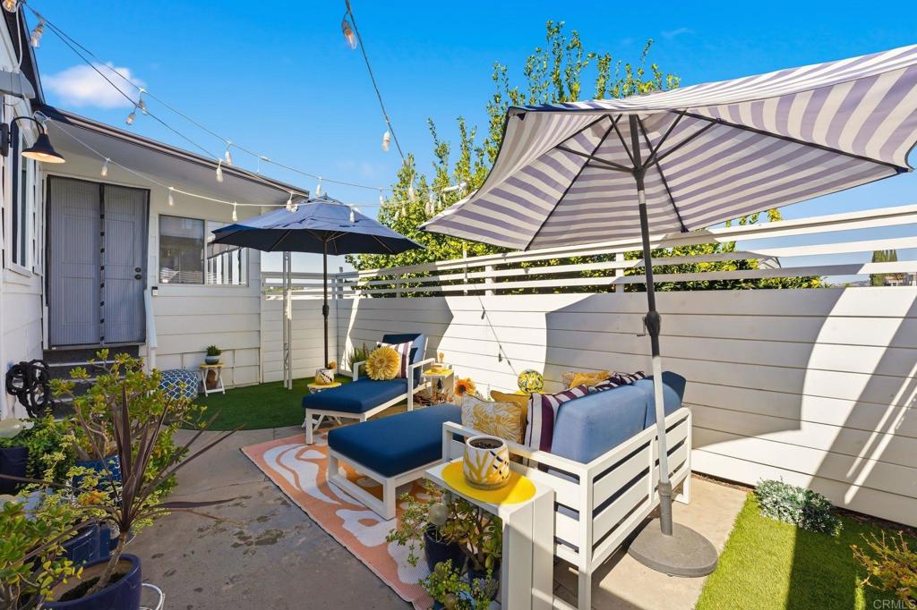 1195 La Moree Road, Unit 98 San Marcos, CA 92078 - Photo 25 of 28 a view of a patio with table and chairs under an umbrella