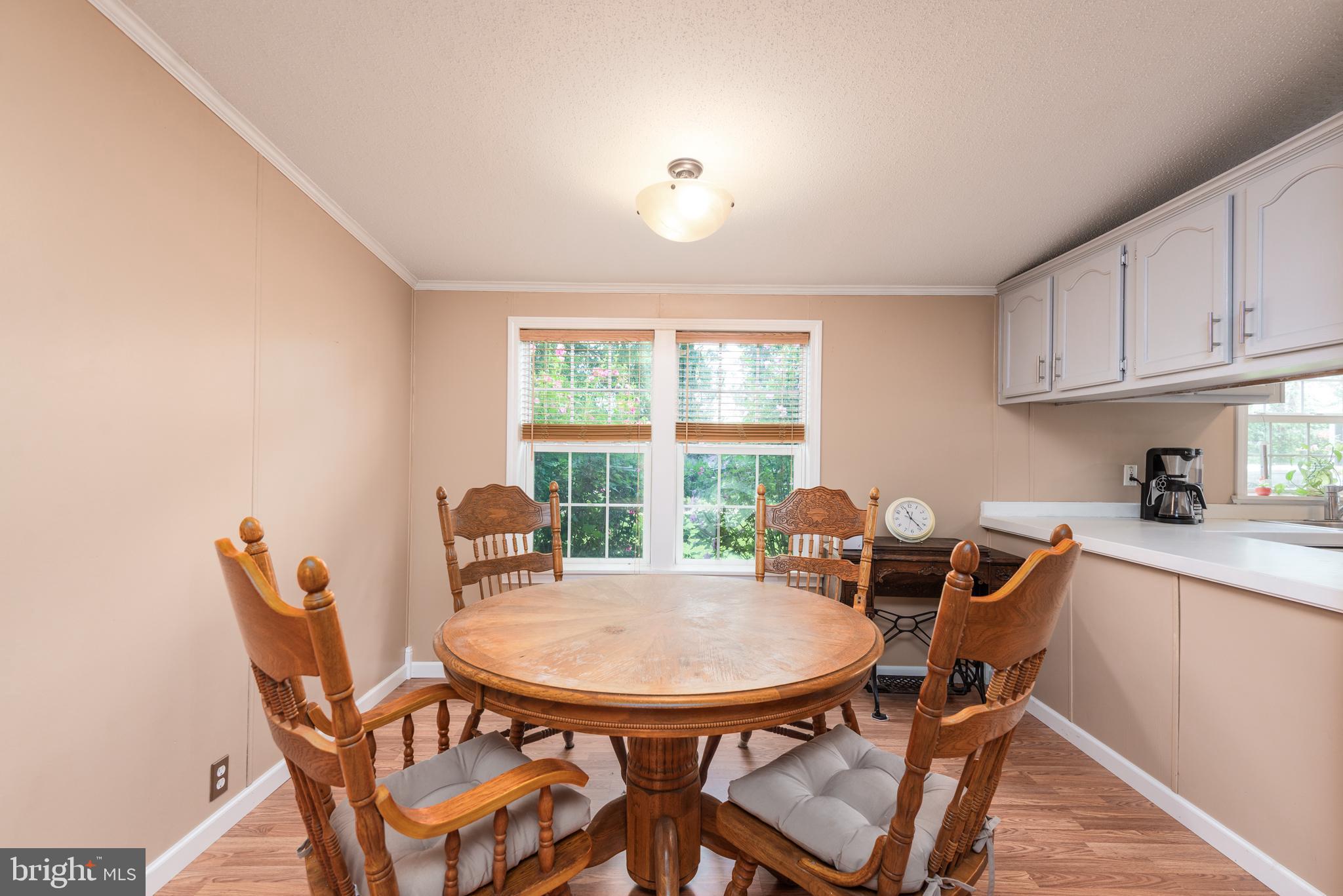 146 Bear Pond Road Marydel, MD 21649 - Photo 14 of 29 a view of a dining room with furniture and a window