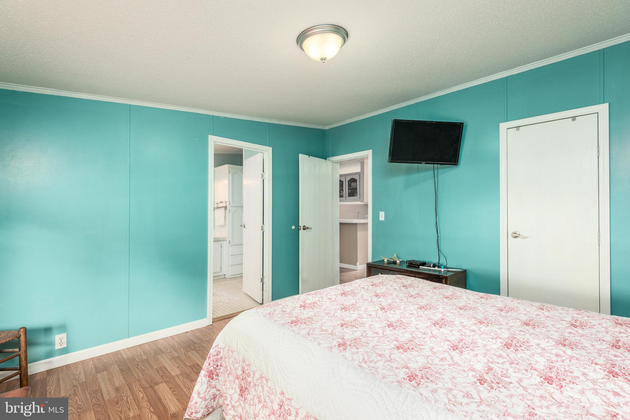 146 Bear Pond Road Marydel, MD 21649 - Photo 17 of 29 a bedroom with a bed and a flat screen tv