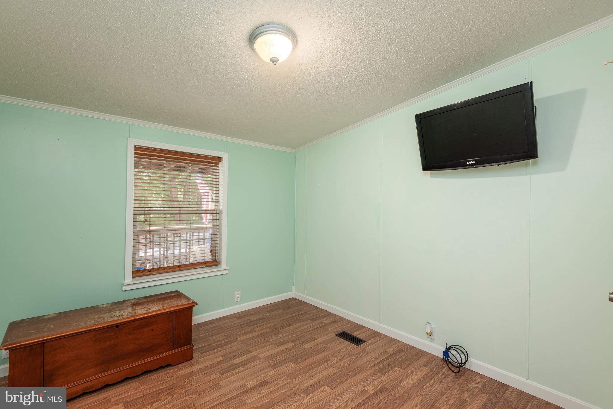 146 Bear Pond Road Marydel, MD 21649 - Photo 20 of 29 a view of room with wooden floor and windows