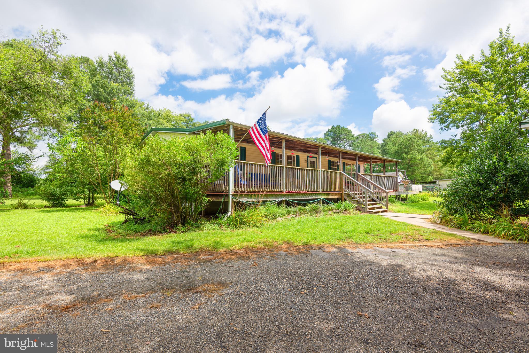 146 Bear Pond Road Marydel, MD 21649 - Photo 2 of 29 a view of a house with a yard and sitting area