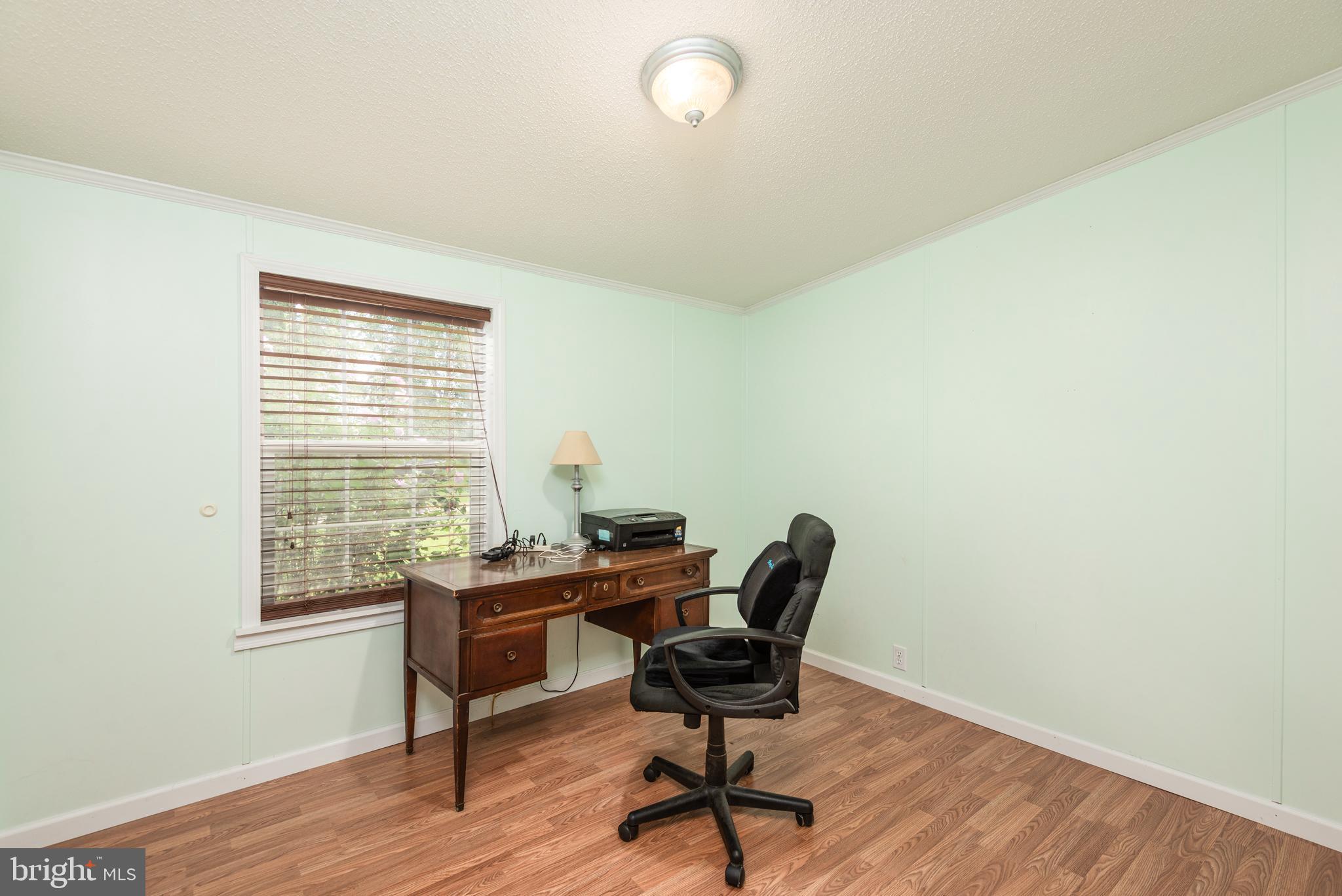 146 Bear Pond Road Marydel, MD 21649 - Photo 22 of 29 a view of a workspace with furniture and a window