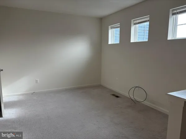 a bathroom with a granite countertop sink a toilet and a mirror