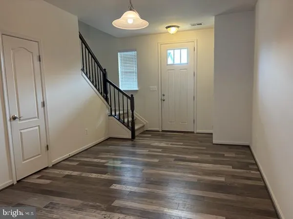 a view of an entryway with wooden floor