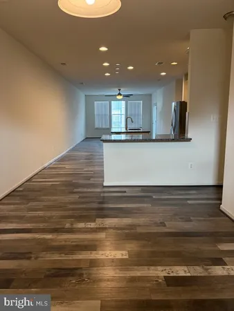 a view of kitchen and empty room