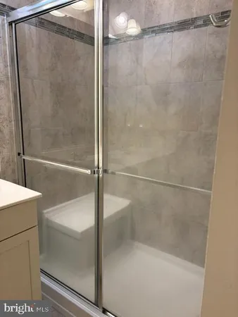 a bathroom with a glass shower door