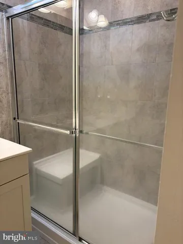 a bathroom with a glass shower door