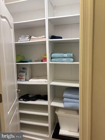 a view of walk in closet with empty racks