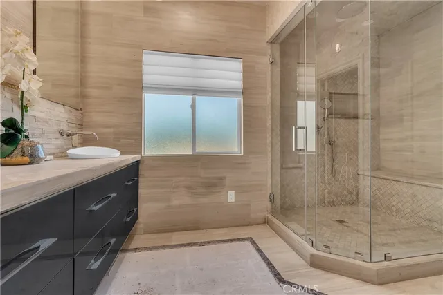 a bathroom with a double vanity sink mirror and shower
