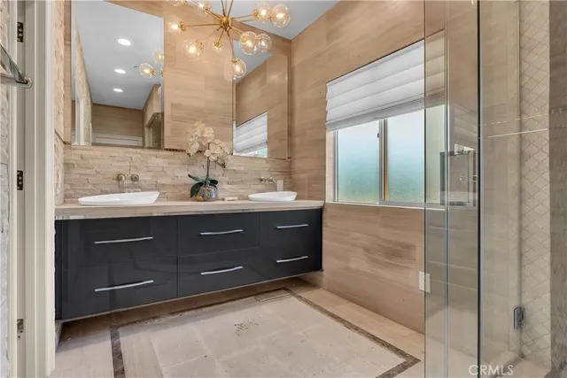 a spacious bathroom with a sink a mirror and shower
