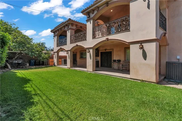 a view of a house with brick walls and a yard with plants