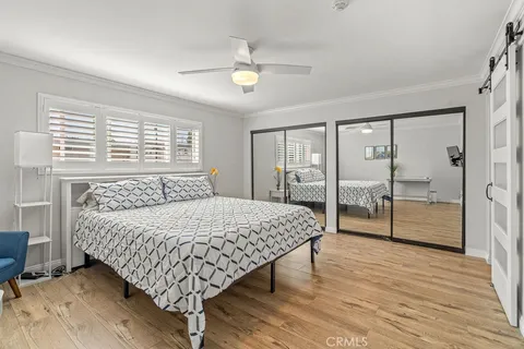 a bedroom with a large bed and a chandelier