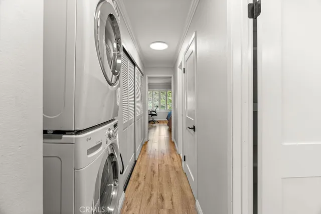 a view of a hallway with wooden floor and staircase