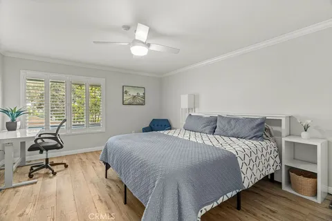 a bedroom with a bed a table and a chandelier