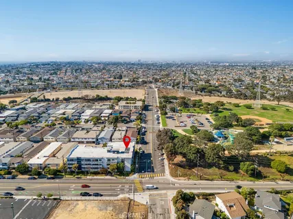 an aerial view of residential building with cars parked