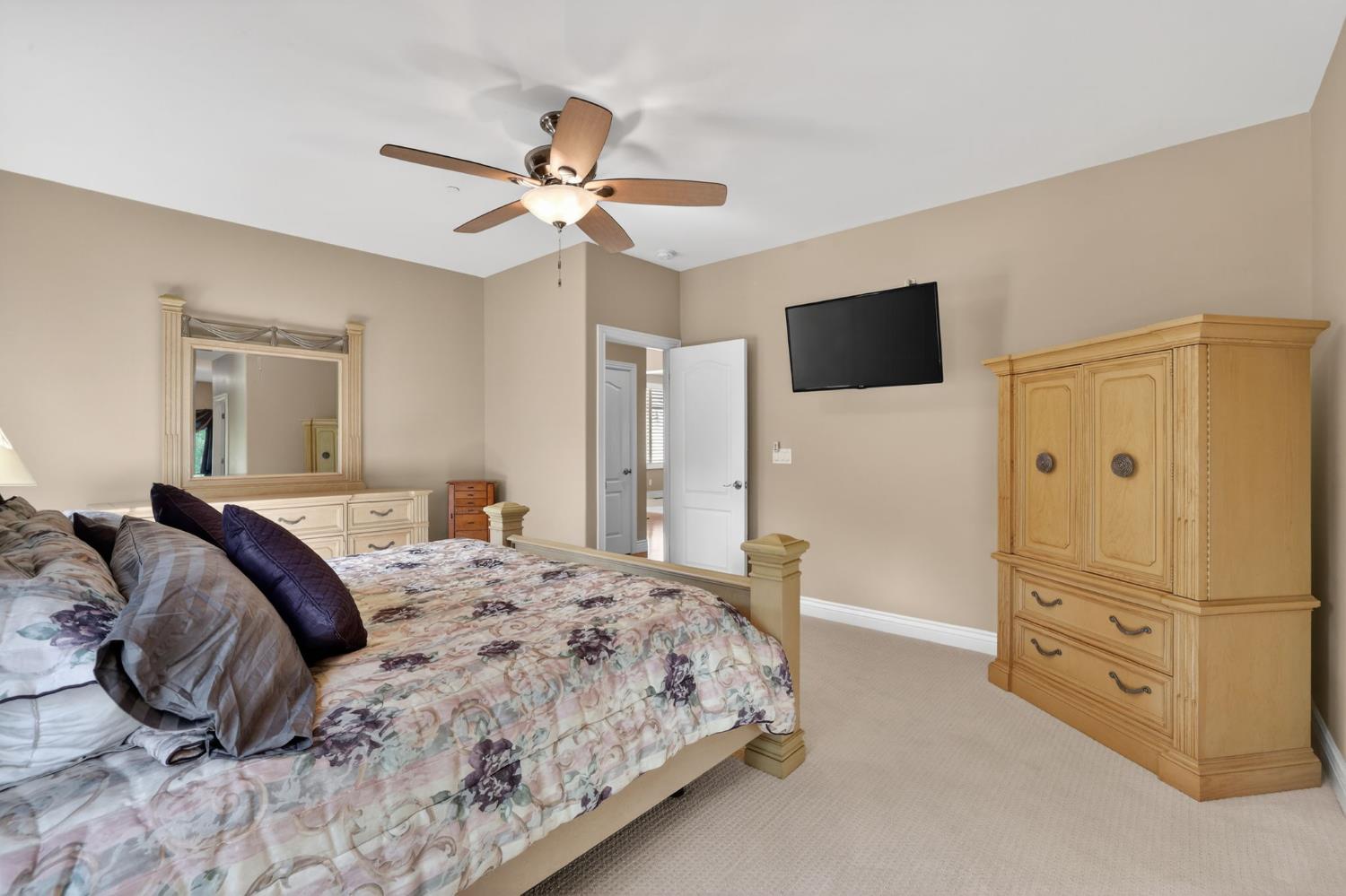 4554 Cross Creek Road Cool, CA 95614 - Photo 31 of 92 a bedroom with a bed and a flat screen tv