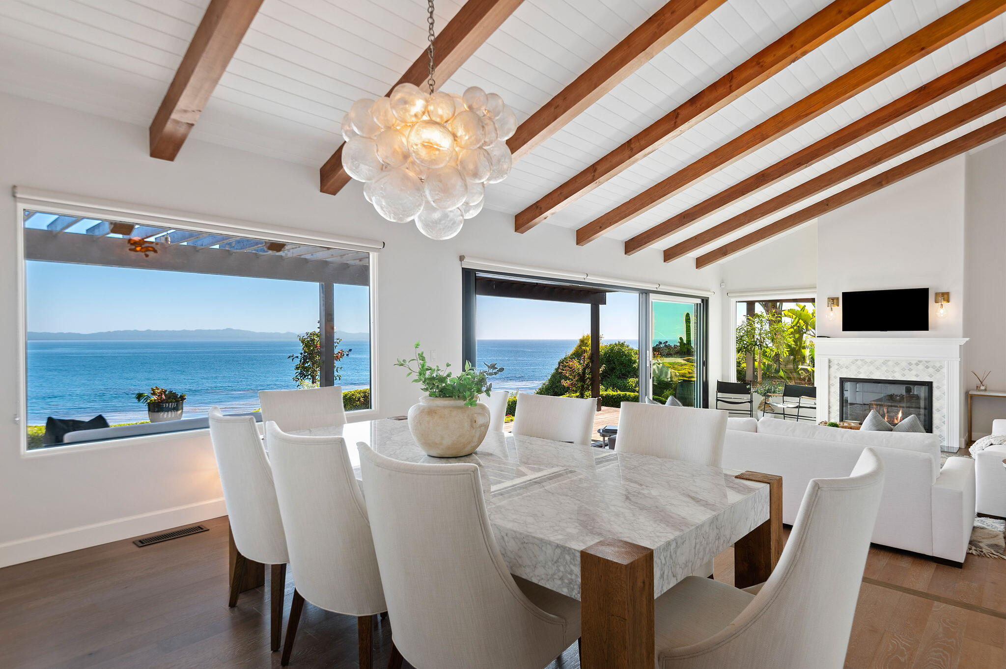 1409 Shoreline Drive Santa Barbara, CA 93109 - Photo 12 of 37 a view of a dining room with furniture a chandelier and large windows