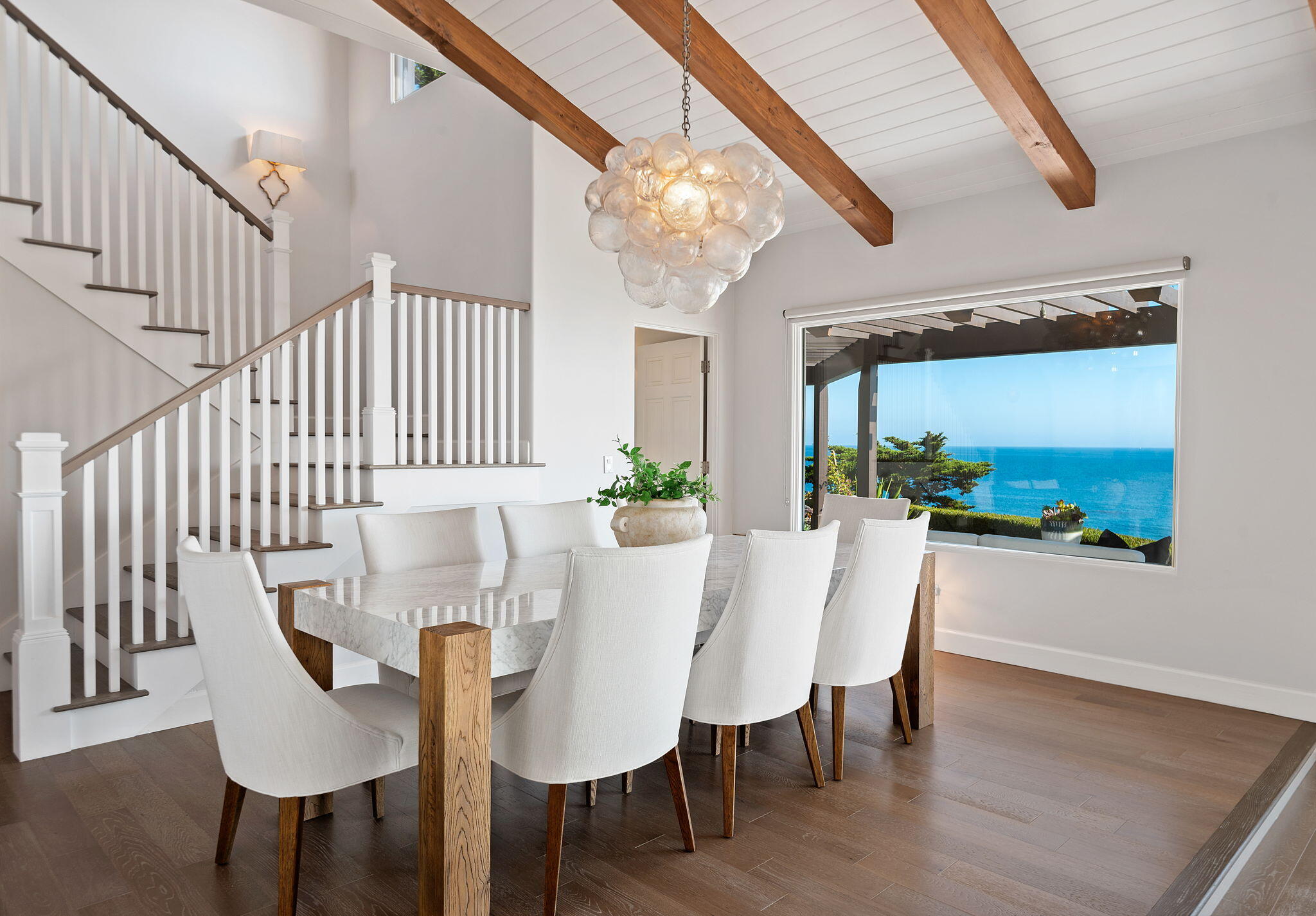 1409 Shoreline Drive Santa Barbara, CA 93109 - Photo 14 of 37 a view of a dining room with furniture a potted plant and wooden floor