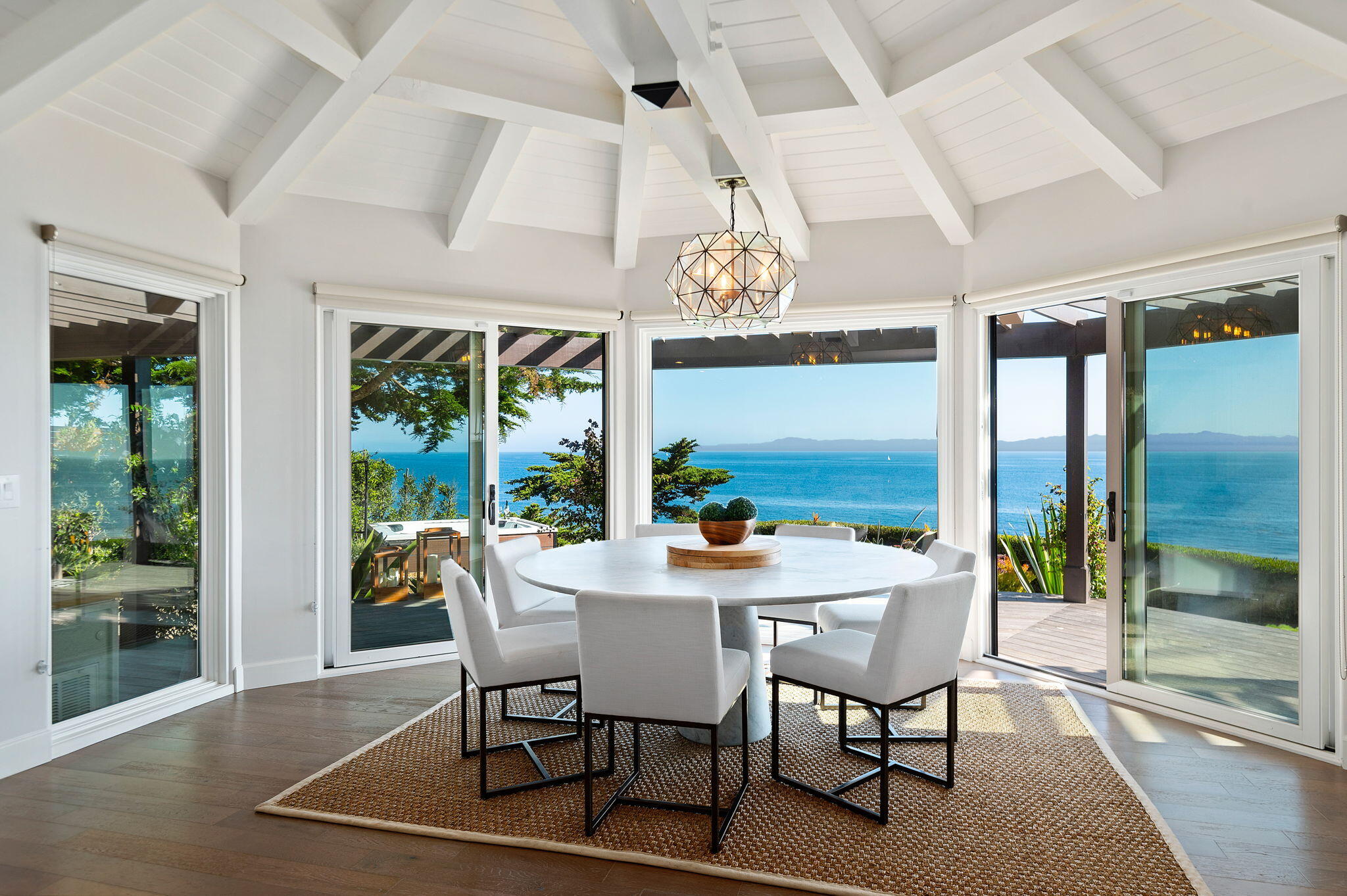 1409 Shoreline Drive Santa Barbara, CA 93109 - Photo 15 of 37 a view of a dining room with furniture wooden floor and chandelier