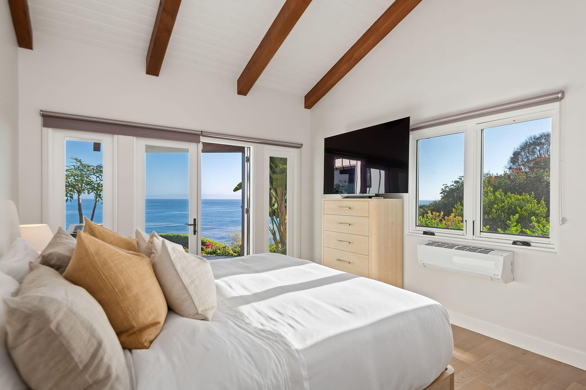 1409 Shoreline Drive Santa Barbara, CA 93109 - Photo 22 of 37 a bedroom with a large bed and a large window