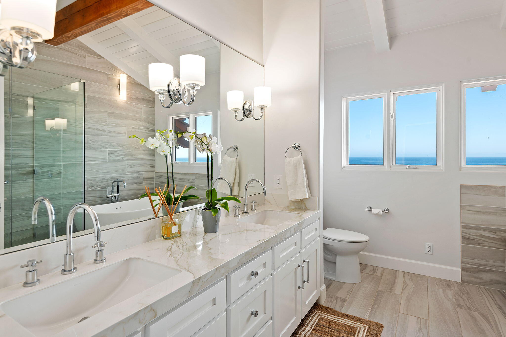 1409 Shoreline Drive Santa Barbara, CA 93109 - Photo 23 of 37 a bathroom with a double vanity sink and a mirror