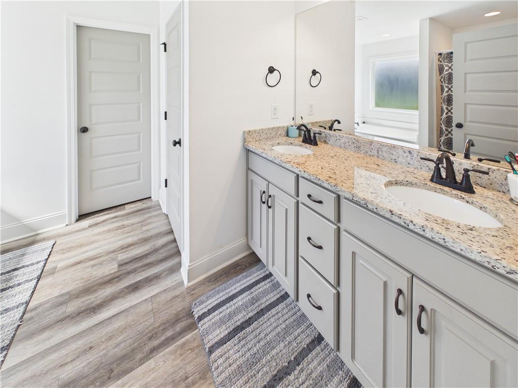 52 Owens Road Fort Mitchell, AL 36856 - Photo 17 of 29 Dual vanity with granite countertop and undermount sinks, featuring matte black fixtures and light-colored cabinetry