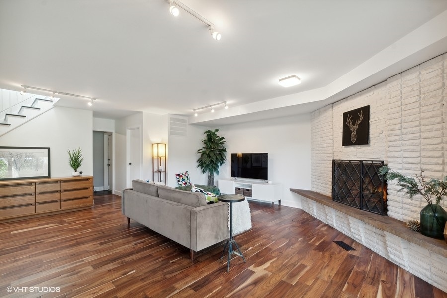 1691 Berkeley Road Highland Park, IL 60035 - Photo 8 of 25 a living room with fireplace furniture and a flat screen tv